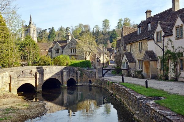  Historic stone bridge and honey-coloured cottages in a Cotswold village on the Cotswold Way walking holiday route